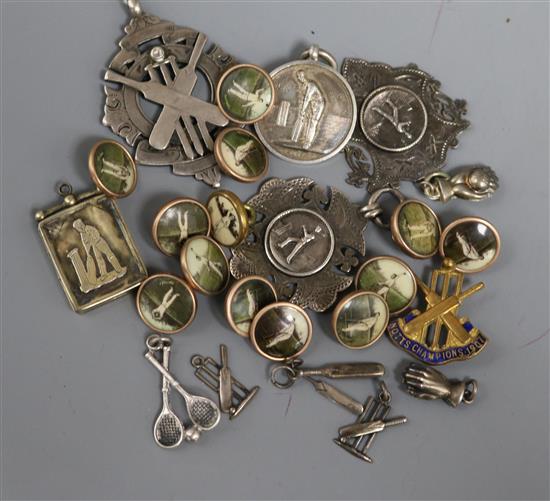 Twenty six assorted cricket related items including silver medallions, white metal charms, silver locket and buttons.